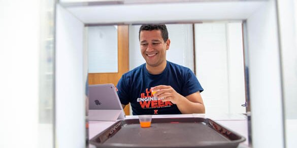 Student smiling while testing food