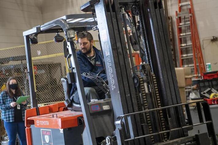 Daniel Gaither operates a forklift inside of a warehouse